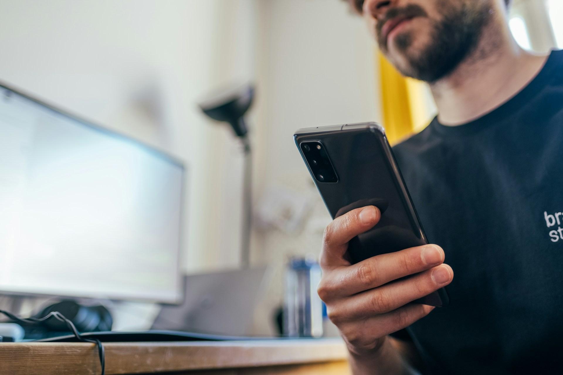 Image of a man holding a smartphone